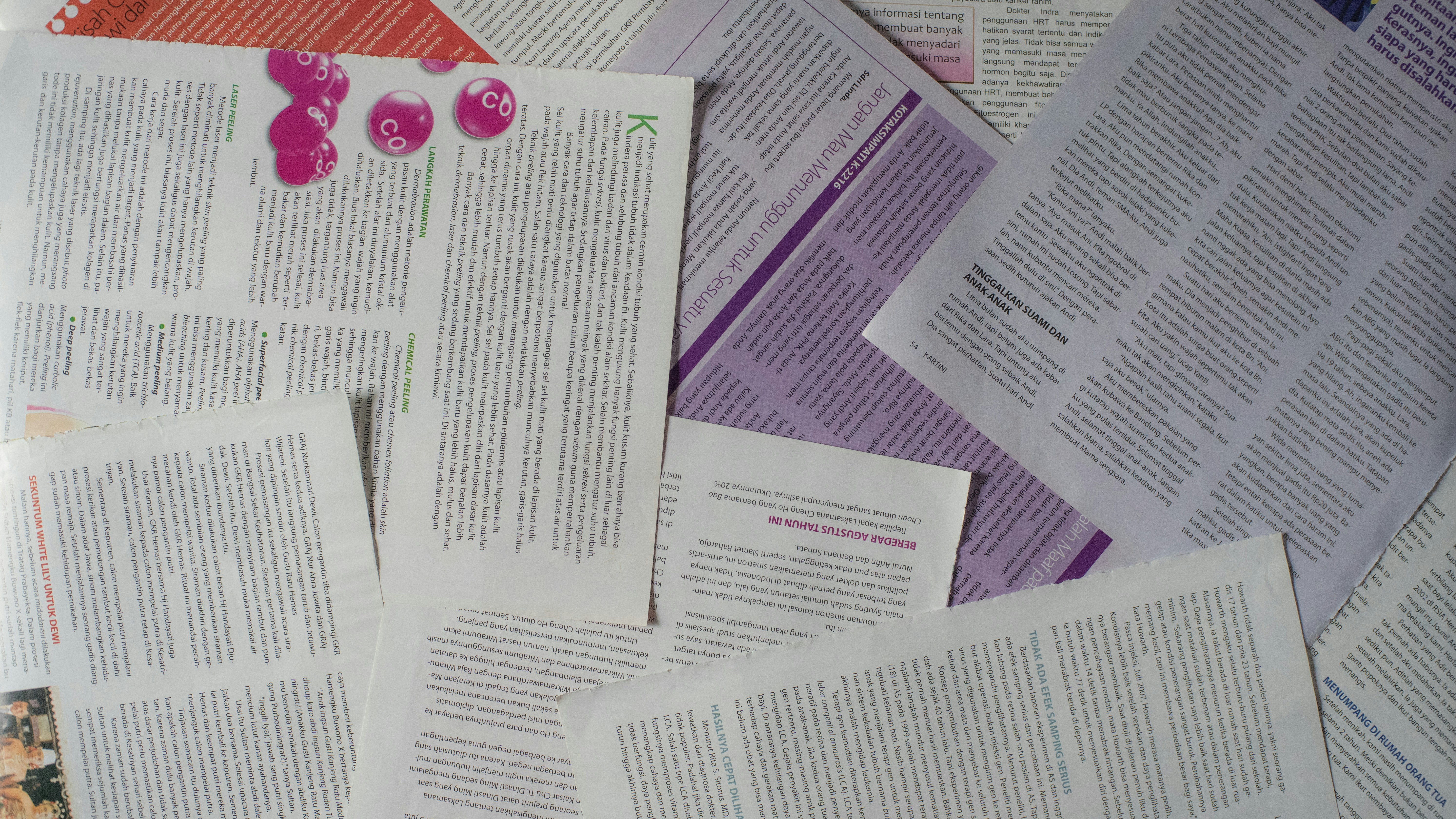 Pages from scattered peer-reviewed medical journals overlapping on a desk